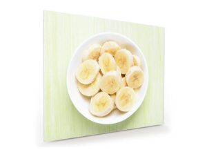 Primedeco Glasbild Wandbild Bananen auf Teller mit Aufhängung